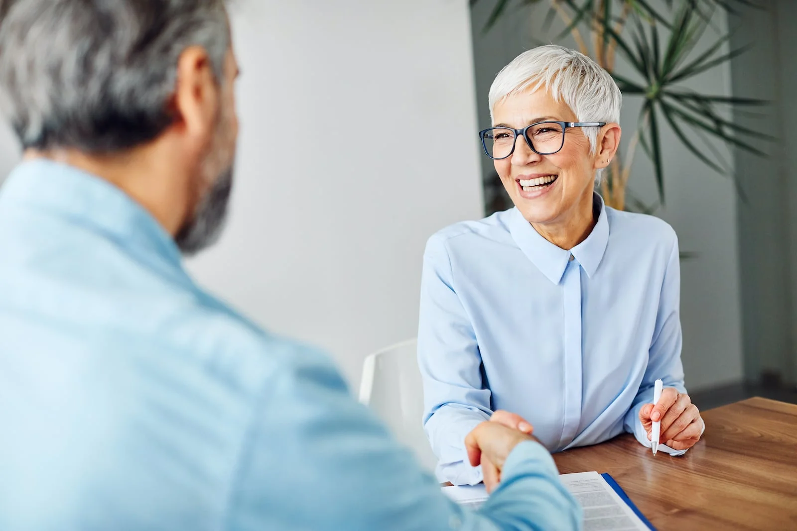 mature_businesswoman woman shaking hands with man